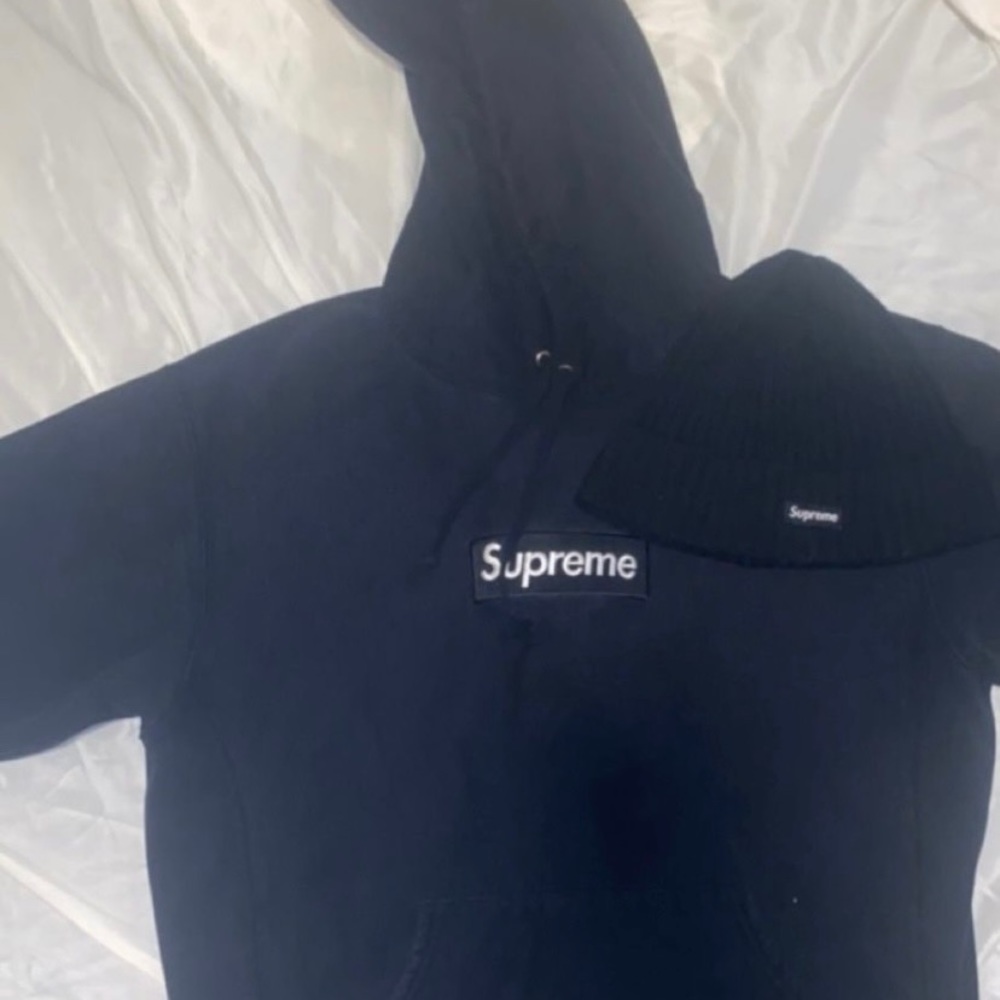 Black supreme hoodie and matching hat.